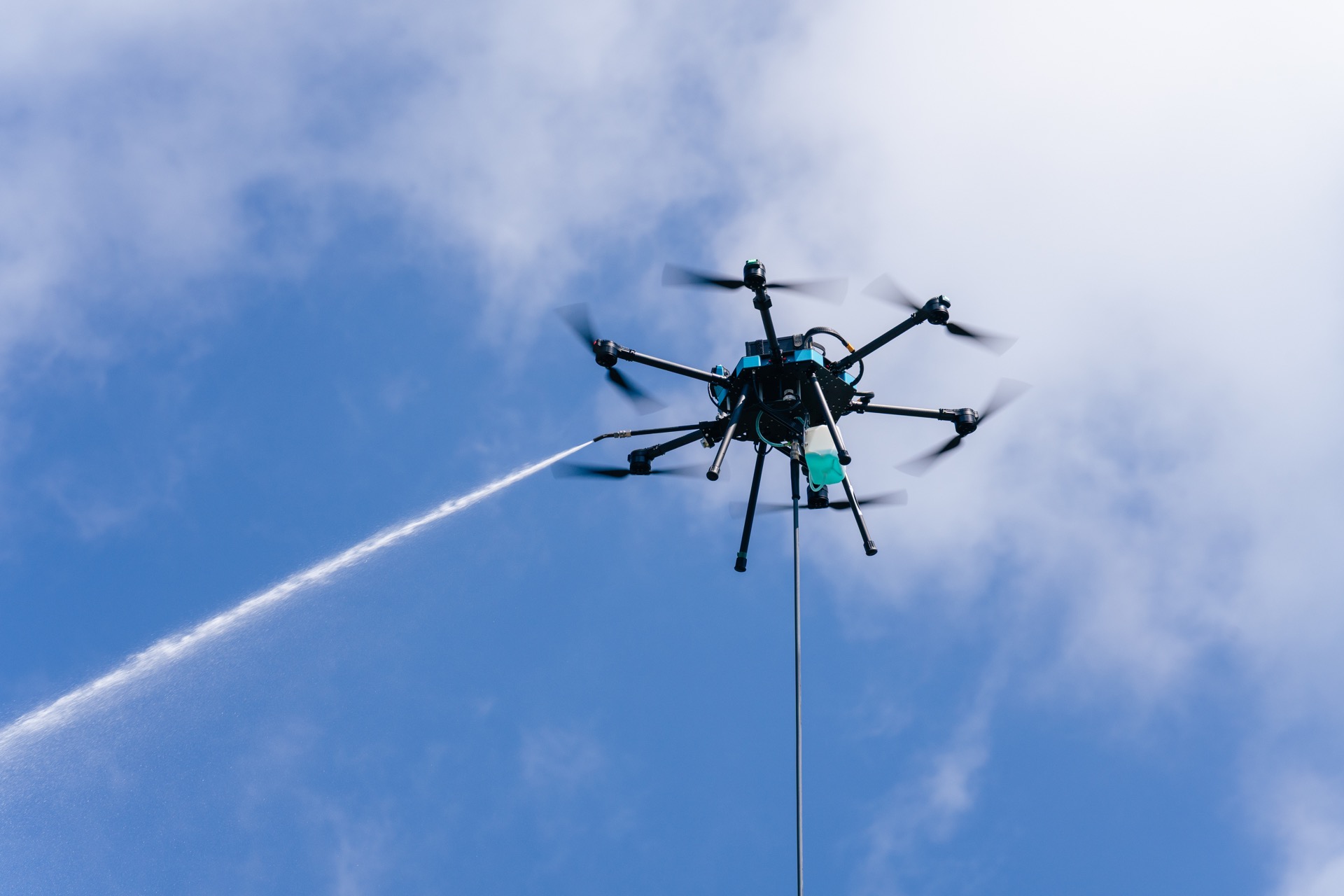 SkyWash Coastal cleaning drone spraying water at an industrial site